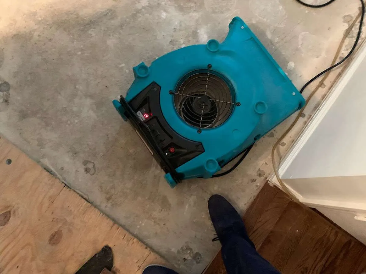 Air mover drying subfloor during Commercial Water Damage Restoration in Nottingham